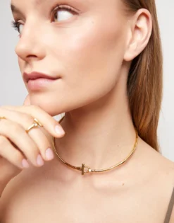 Collar rígido con cierre frontal bañado en oro 18k con topacio blanco