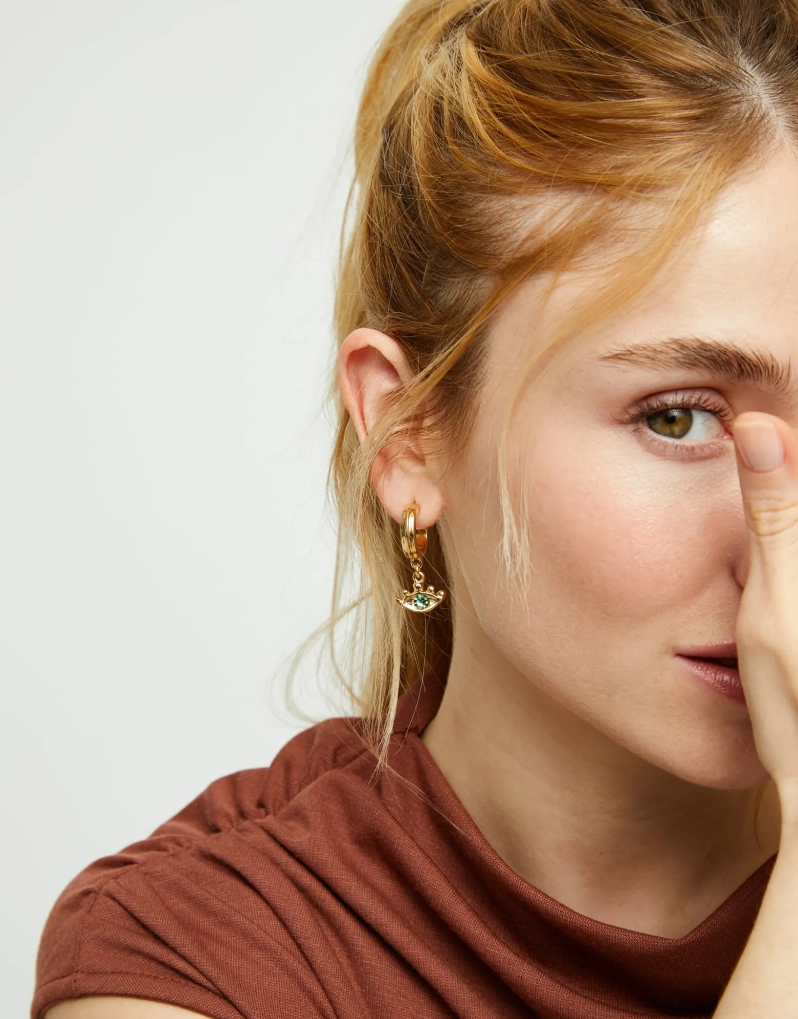 Pendientes de aro bañados en oro 18k con forma de ojo y cristal facetado verde