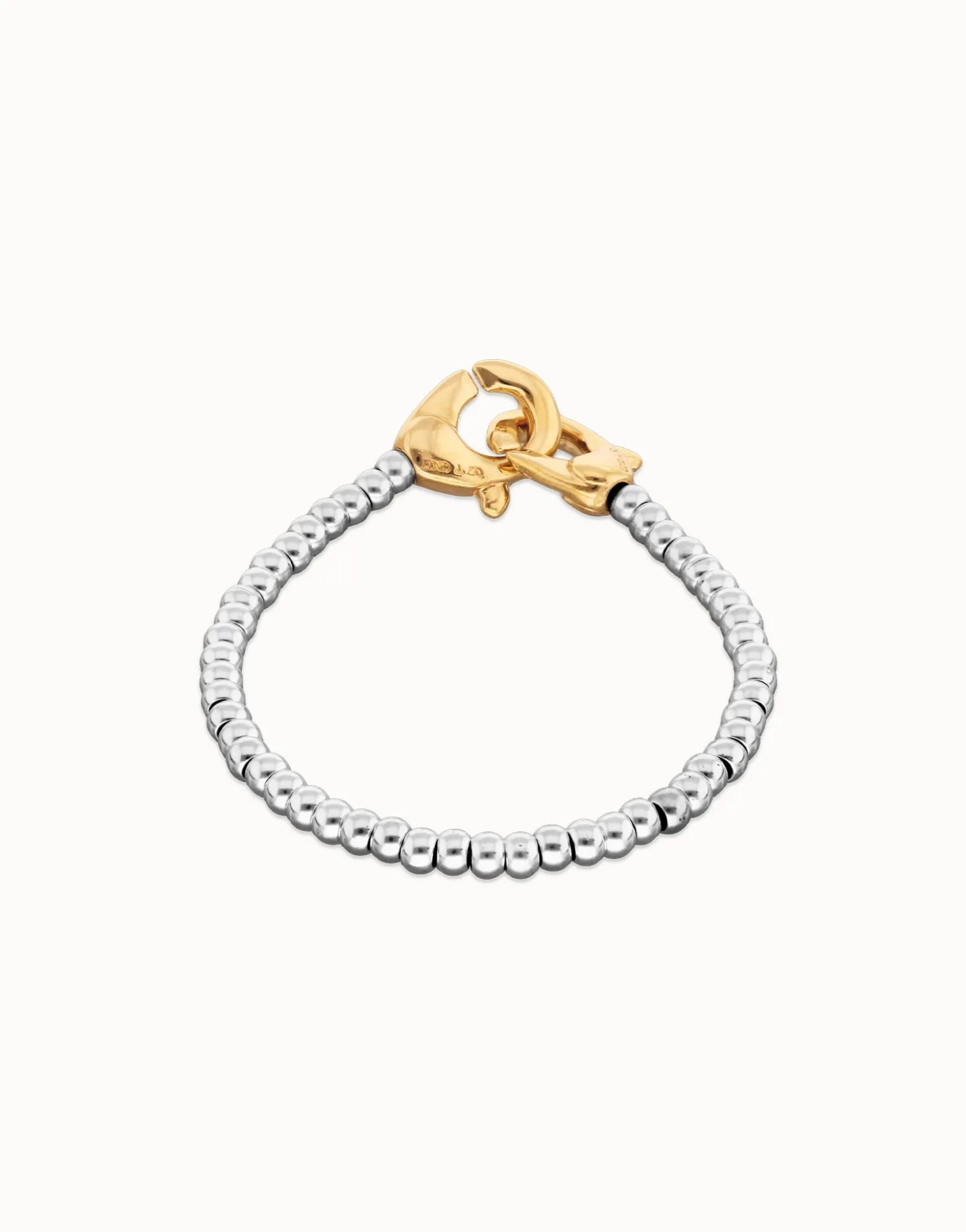 Pulsera de bolas pequeñas bañada en oro con mosqueton entrelazado en oro