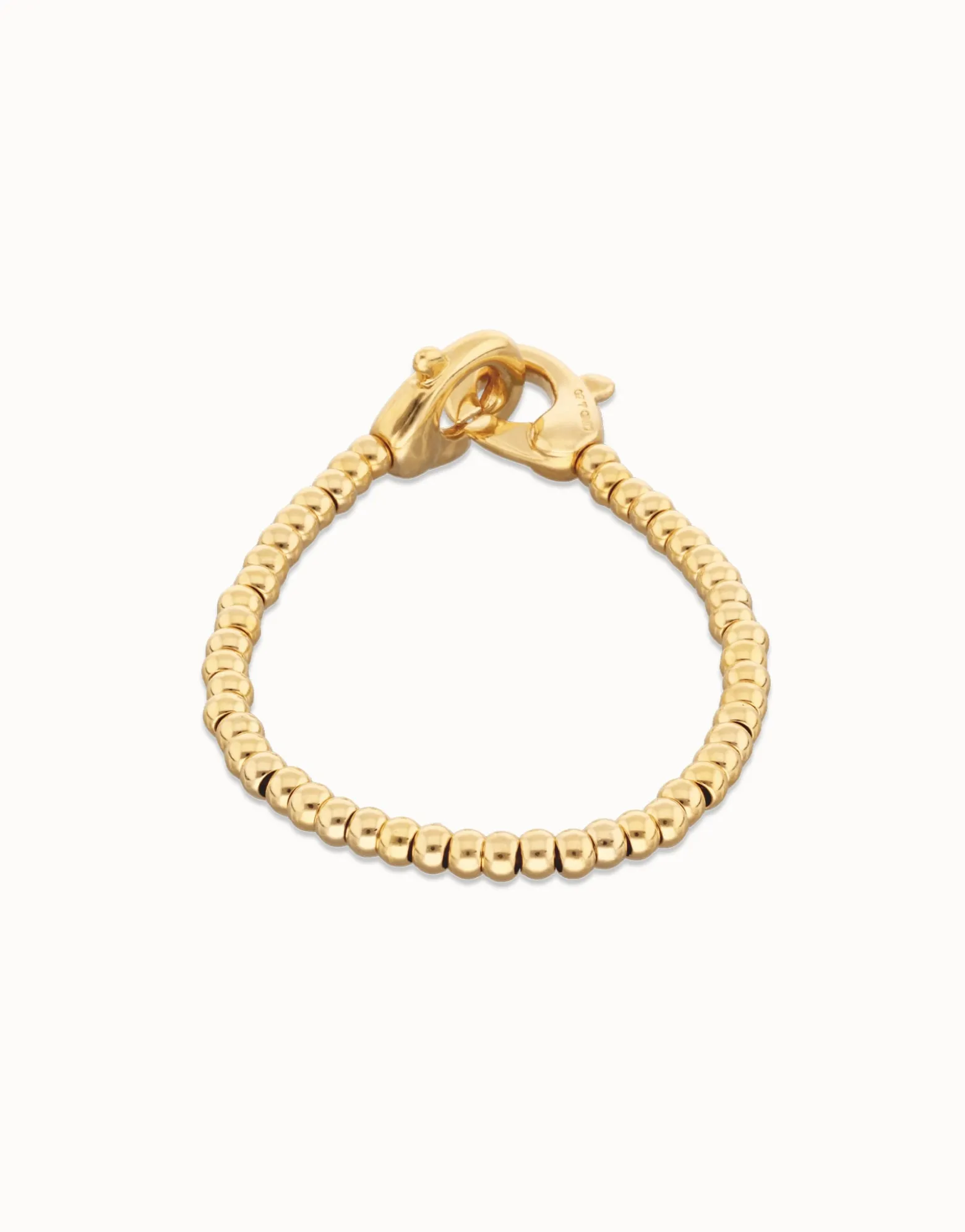 Pulsera de bolas pequeñas bañada en oro con mosquetón entrelazado