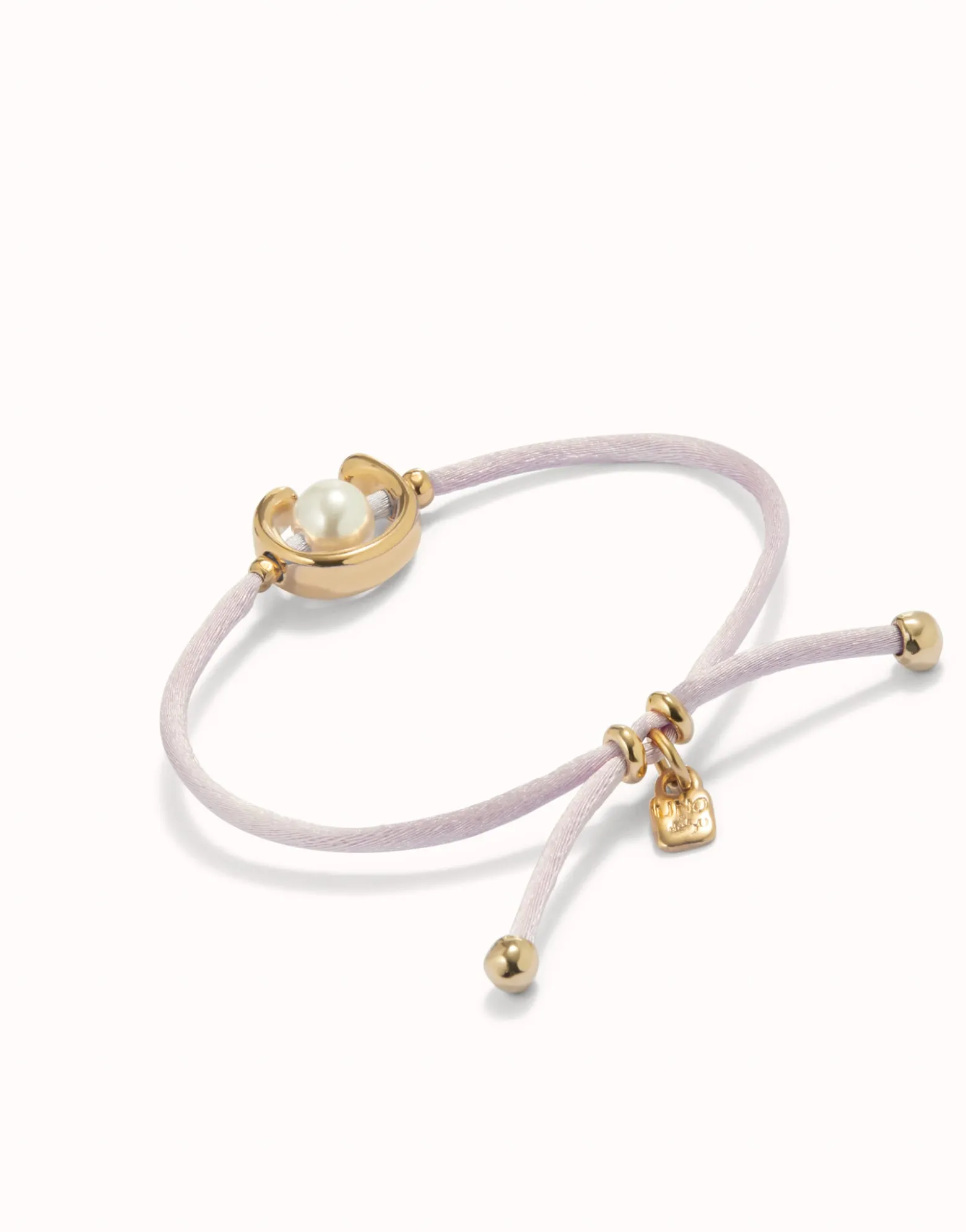 Pulsera de hilo lila con perla shell fornitura bañada en oro 18k.